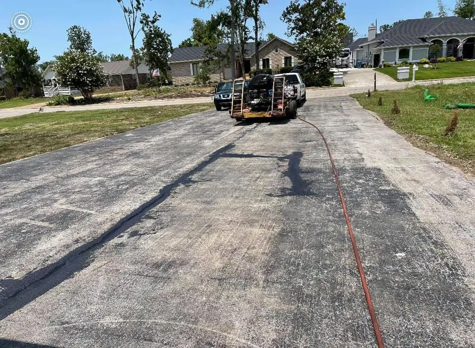 Unloading equipment before repairing a driveway.